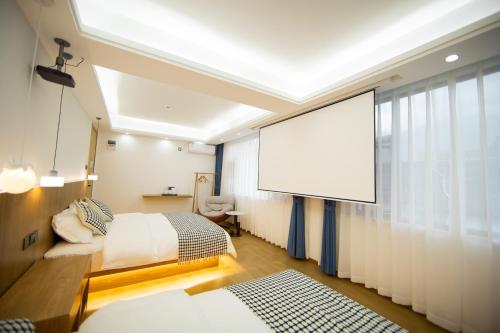 Et tv og/eller underholdning på Feihua Qingmeng Homestay