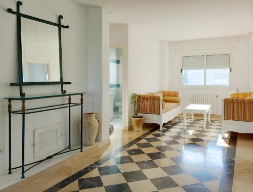 a living room with a black and white checkered floor at Villa Souad - havre de paix et charme tunisien aux portes de Tunis in La Marsa