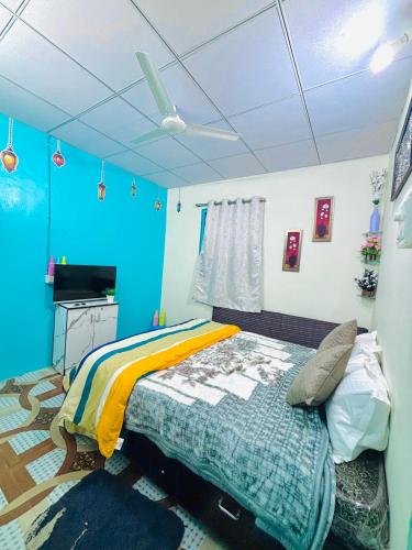 a bedroom with a bed in a room with blue walls at KKOZY NOOk in Aurangabad