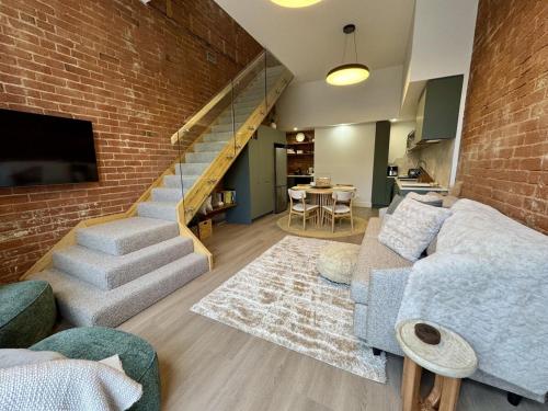 a living room with a couch and a brick wall at Mylan on Marine - Historic Charm, Modern Heart in Burnie