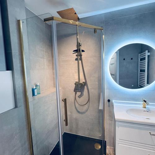 a bathroom with a shower and a sink at Studio 9 Żeromskiego in Gorzów Wielkopolski