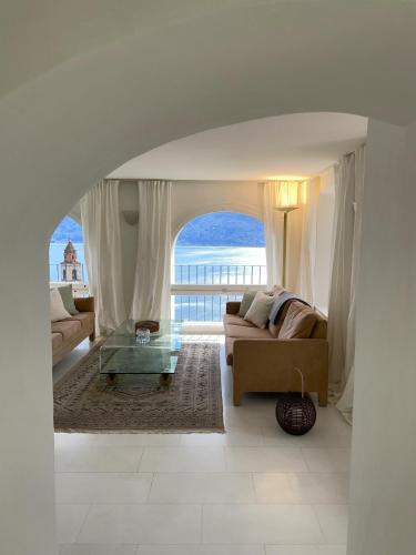 a living room with a couch and a view of the ocean at Il Nido by Fewotessin in Ronco sopra Ascona