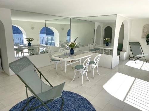 a living room with a table and chairs at Il Nido by Fewotessin in Ronco s/Ascona - Porto Ronco