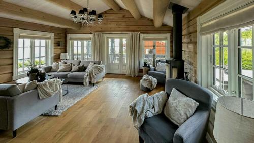 a large living room with couches and a fireplace at Log Cabin With Panoramic Views At Voss Resort in Skulestadmo