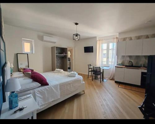 a bedroom with a large bed and a kitchen at A Casa Di Ugo in Fisciano