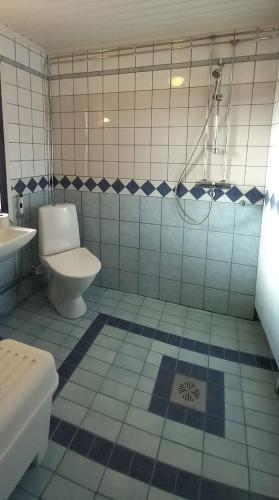 a blue and white bathroom with a toilet and a sink at Kotariipi in Saukkoriipi
