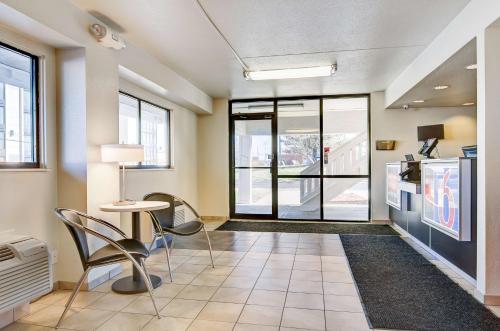 a lobby with a table and chairs and a kitchen at Motel 6-Springfield, MO - North in Springfield