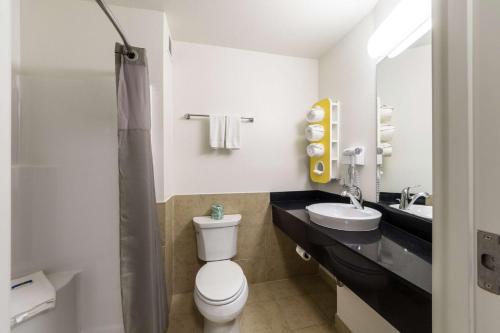 a bathroom with a toilet and a sink at Motel 6-Laredo, TX - Airport in Laredo