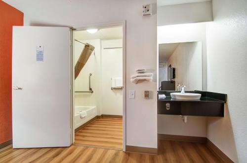 a bathroom with a sink and a mirror at Motel 6-Springfield, MO - North in Springfield