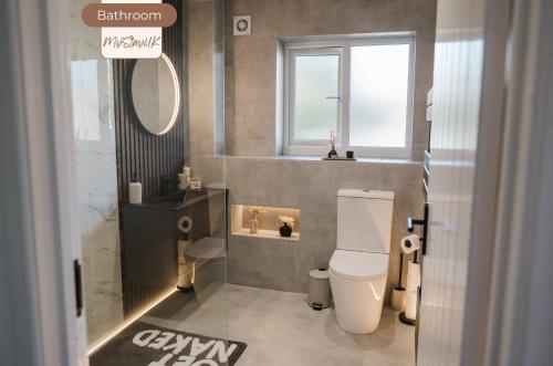 a bathroom with a toilet and a sink and a mirror at 3BR House By MyStayUK Short Lets & Serviced Accommodation Manchester With Free Parking & Contractor Stays in Manchester