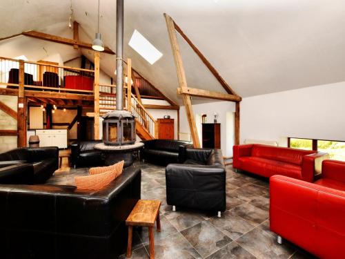 a living room with leather furniture and a fireplace at Modern Holiday Home in Meyerode with Terrace in Meyerode