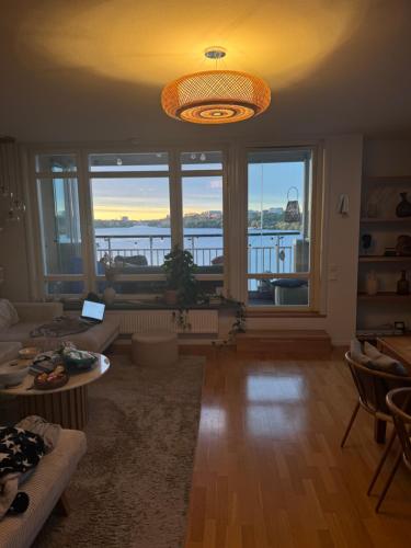 a living room with a view of the water at Central waterfront luxury penthouse in Stockholm