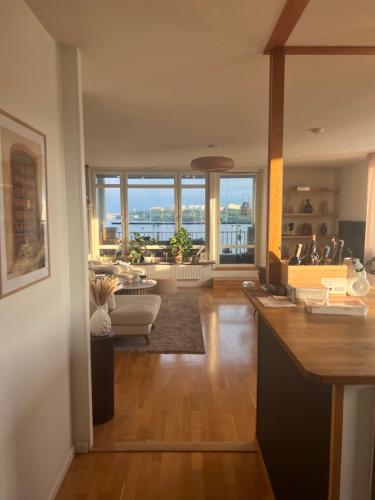 a kitchen and living room with a view of a living room at Central waterfront luxury penthouse in Stockholm