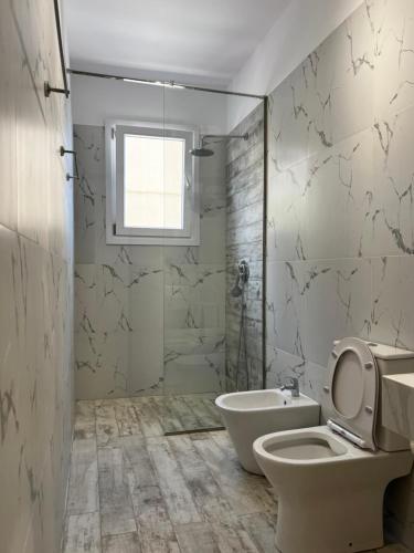 a bathroom with a toilet and a sink and a shower at Greco Mare 99 in Kavos
