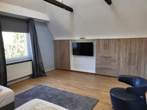 a living room with a flat screen tv and a couch at Ferienhaus Strandoase in Oldenburg in Holstein