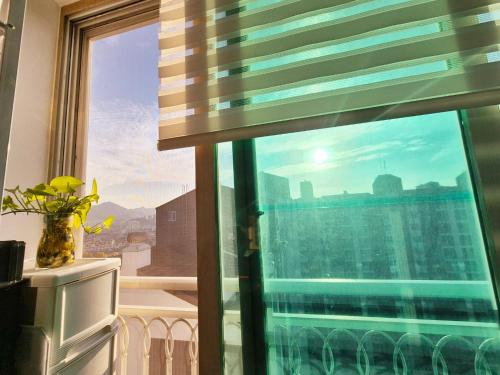 a window with a view of a city skyline at Healing Gangchu in Anyang