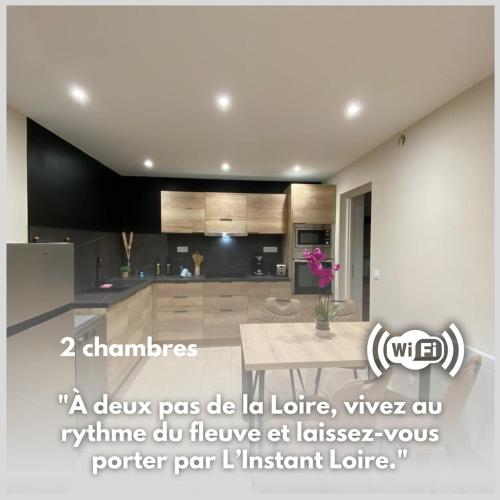 a kitchen with a table in the middle of it at L'Instant Loire in Saumur