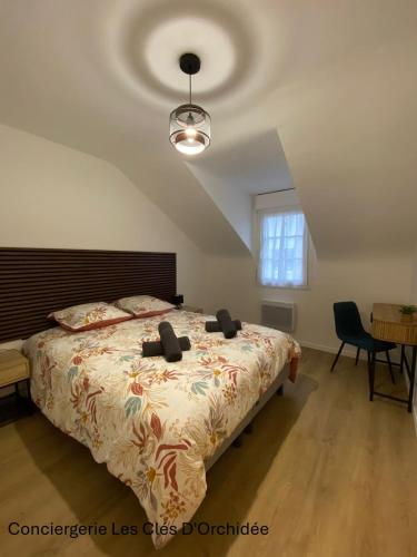 a bedroom with a large bed and a ceiling at L'Instant Loire in Saumur