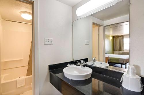 une salle de bain avec un lavabo et un miroir dans l'établissement Motel 6-Dallas, TX - Forest Lane, à Dallas