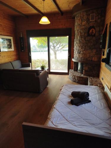 a living room with a large bed in a room with a fireplace at Dream PARADISE in Nea Michaniona