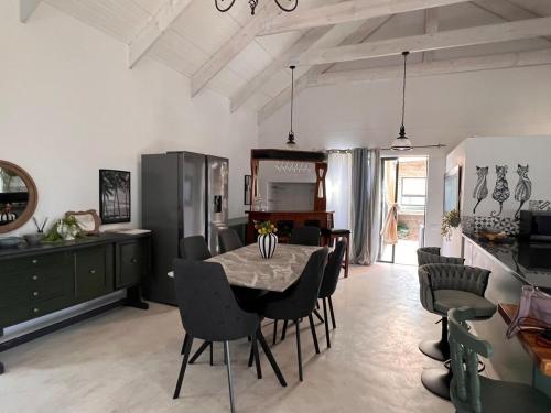 eine Küche und ein Esszimmer mit Tisch und Stühlen in der Unterkunft Blue Bay Villa in Saldanha