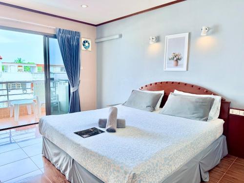 a bedroom with a bed with a view of a balcony at CHA AM MY HOUSE Resort in Cha Am