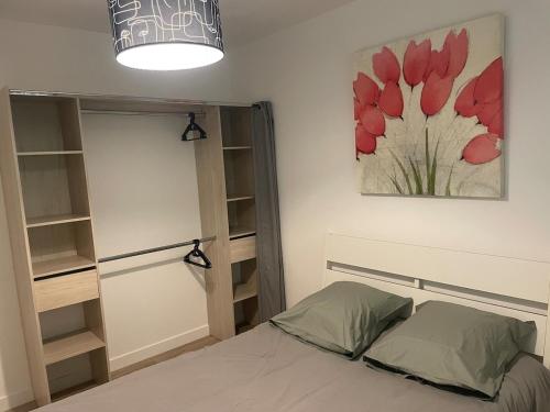 a bedroom with a bed and a painting on the wall at Port de Rochefort in Rochefort