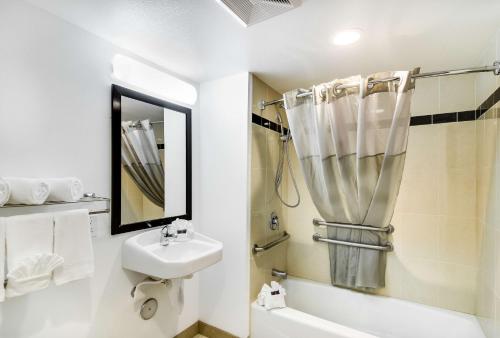 a white bathroom with a sink and a shower at Motel 6-Carson, CA in Carson