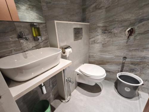 een badkamer met een wastafel en een toilet bij Hotel Melody Boutique Thane in Thane