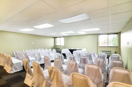 a room with white chairs and tables in it at Motel 6-Carson, CA in Carson