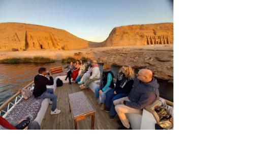 a group of people sitting on a boat in the desert at Summer Land Hotel in Abu Simbel