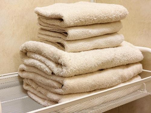 a stack of towels sitting on a shelf at 芋ノ宿ー大正 in Osaka