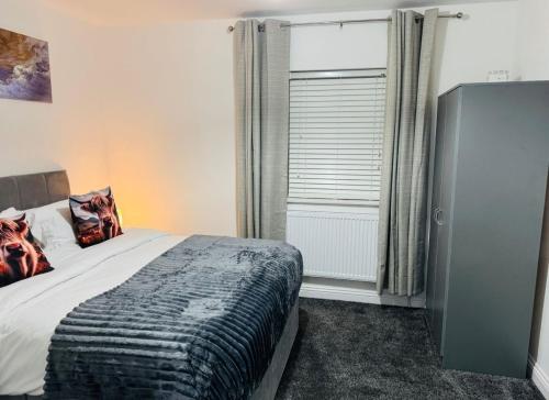 a bedroom with a bed and a large window at Modern 1BR Home in Clayton-le-moors in Clayton le Moors