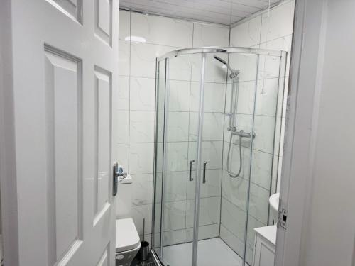 a bathroom with a glass shower with a toilet at Modern 1BR Home in Clayton-le-moors in Clayton le Moors