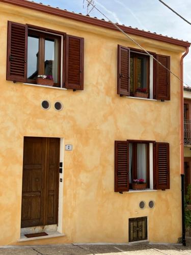 a house with two windows and a door at Corte 'e Susu - Domo Experience in Ortueri