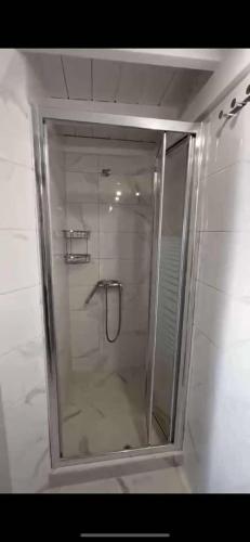 a shower with a glass door in a bathroom at Aegean View Apartment in Skala Eresou