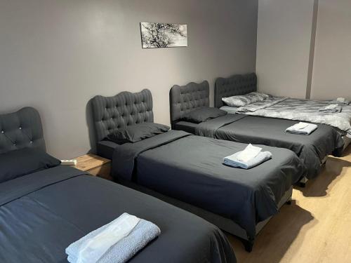 a room with three beds with towels on them at Nur Sena's House in Istanbul