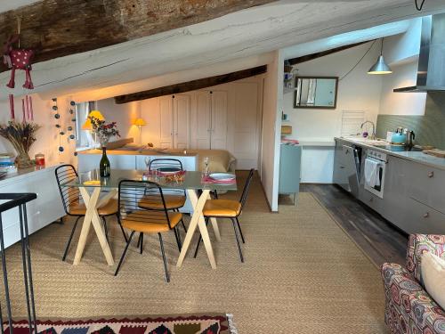 a kitchen and living room with a table and chairs at Lovely views in secret Provence in Joucas