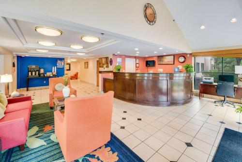 a lobby of a hotel with chairs and a desk at Motel 6-Milford, CT in Milford
