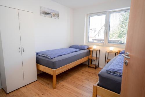 En eller flere senge i et værelse på Kuku Ruku Zimmervermietung 12-2