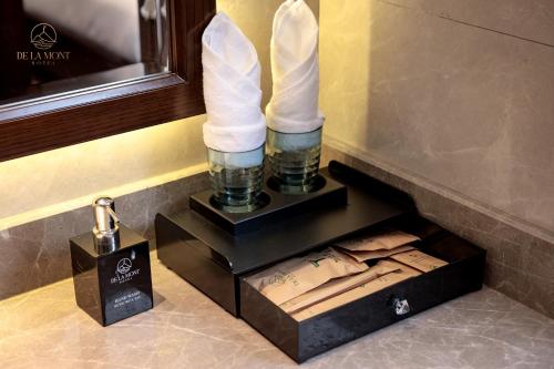 a box with two white swans in a room at De La Mont Hotel Ha Giang in Ha Giang