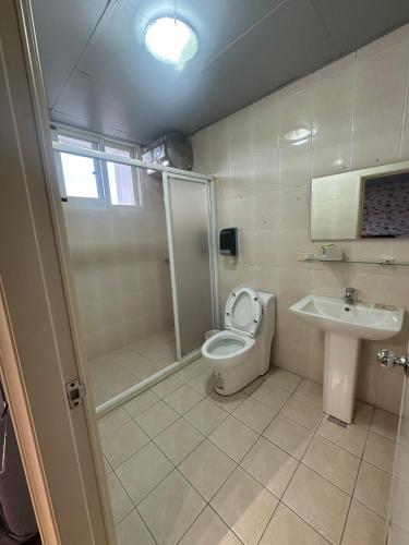 a bathroom with a toilet and a sink at Easy play B&B in Luodong