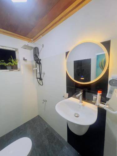 a bathroom with a sink and a mirror at Kekulama Eco Cabana Galle in Galle