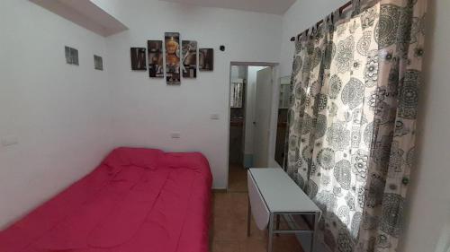 En eller flere senge i et værelse på Minimonoambiente Planta Baja