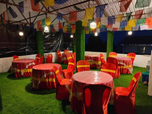 a group of tables and chairs in a tent at The Jasmit Mount View Homestay in Kalimpong