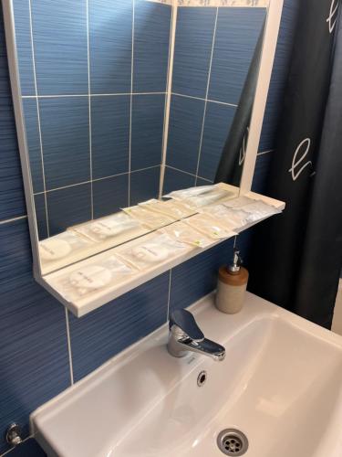a bathroom with a sink and a mirror at Focus Apartment in Miercurea-Ciuc