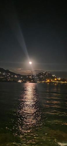 a view of the water at night with the moon at Appartement 4 personnes Cap Estérel centre du village in Saint-Raphaël