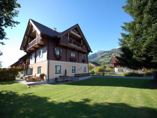 a house with a green lawn in front of it at Renovated Mountain Retreat Stay in Pruggern