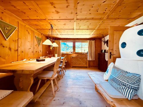 a dining room with a wooden table and chairs at Haus Freistabl in Sölden