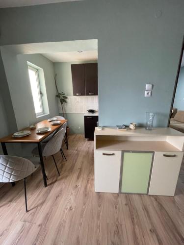 a kitchen and dining room with a table and a dining room at Itan’s apartments in Tirana